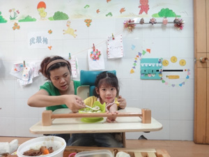 YL learns to use her hands in the rehabilitation centre.