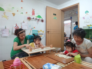 YL learns to use her hands in the rehabilitation centre.